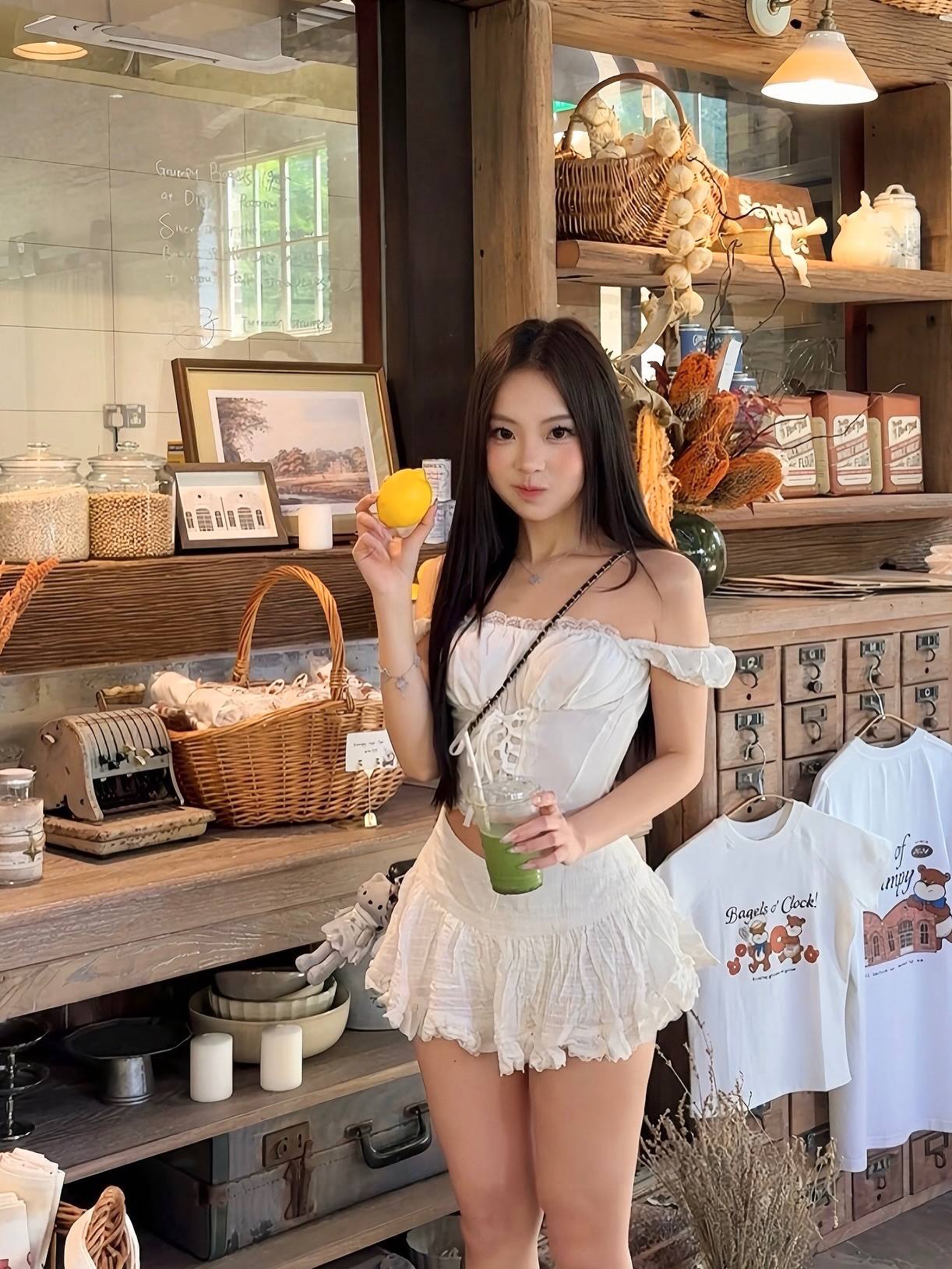 Man wearing a long-sleeve shirt with a moonshine graphic design in a home setting.