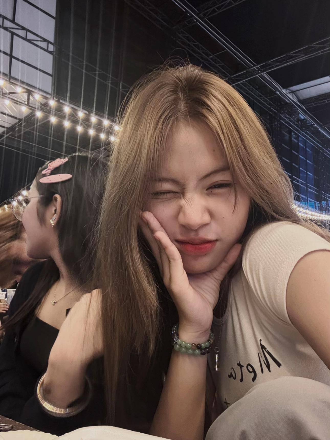 Man wearing a gray tank top with a design on the back, standing outdoors View 2